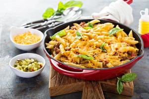 Cheesy pasta bake with ground beef and herbs photo