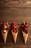 Fresh fruit and berries in waffle cones photo