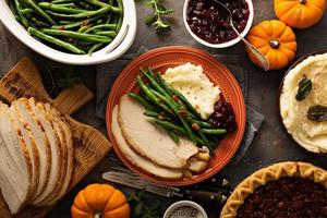 Thanksgiving plate with turkey, mashed potatoes and green beans photo