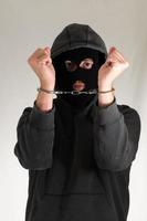 Handcuffed masked man photo