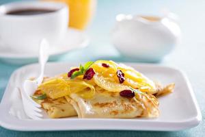 Crepe suzette with orange cranberry sauce photo