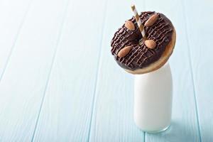 Chocolate almond donut with a bottle of milk photo