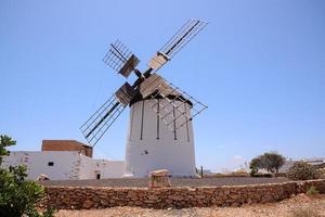 Traditional windmill under clear blue sky photo