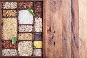 Variety of healthy grains and seeds in a wooden box photo