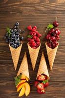 Fresh fruit and berries in waffle cones photo