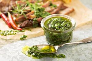 Green chimichurri sauce with grilled steak photo