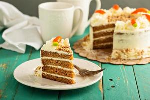 Slice of carrot cake with cream cheese frosting photo