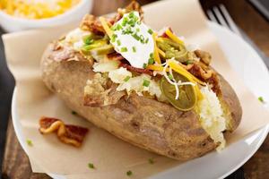 Loaded baked potato with bacon and cheese photo