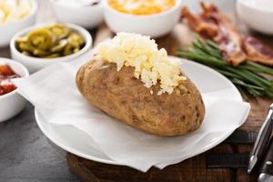 Baked potato buffet with cheese and bacon photo