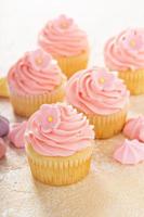 Vanilla cupcakes with pink raspberry frosting photo