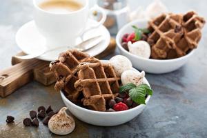 Chocolate waffles with meringues and coffee photo