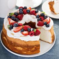 Angel food cake with whipped cream and berries photo