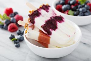 Yogurt, fruit and granola breakfast popsicles photo
