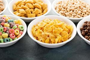 Variety of cold cereals in white bowls photo