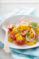 Salad with grilled corn, tomatoes and onion photo