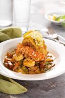 Grits with a lobster tail, shrimp and sausage photo