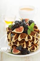 Fluffy breakfast waffles with fresh fruits photo