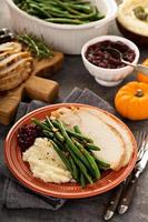 Thanksgiving plate with turkey, mashed potatoes and green beans photo