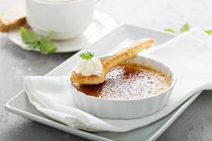 Creme brulee dessert with a cup of cappuccino photo