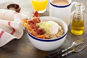 Savory oatmeal porridge with egg and bacon photo