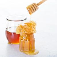 Jar of honey and honeycomb photo