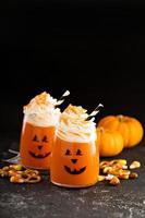 Halloween cold cocktail or drink with jack o'lantern face photo