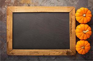 Fall chalkboard frame with pumpkins photo