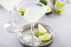 Lemonade martini cocktail garnished with lime photo