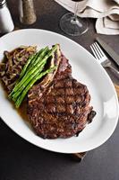 Beef steak with asparagus and mushrooms photo