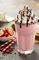 Strawberry milkshake with whipped cream photo