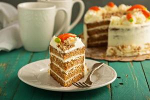 Slice of carrot cake with cream cheese frosting photo