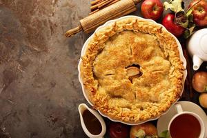 Apple pie decorated with fall leaves photo