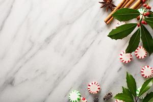 Peppermint candy and spices on marble background photo
