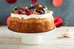 Angel food cake with whipped cream and berries photo