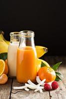 Fresh carrot, orange and coconut juices photo