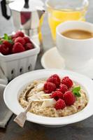 Steel cut oatmeal porridge with raspberry and coconut photo