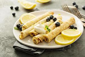 Crepes with lemon filling and blueberries photo