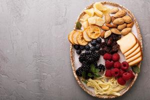 Cheese plate with nuts and berries photo