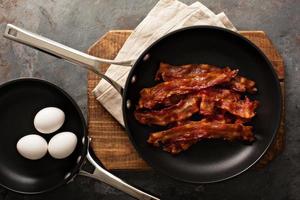 Cooked bacon on a skillet photo