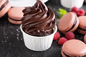 Chocolate cupcakes with thick and glossy frosting photo