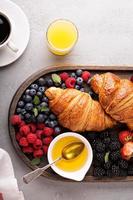 Croissants with fresh berry and honey photo