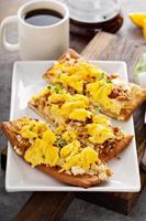 Breakfast pizza, flatbread with scrambled eggs photo
