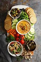 Hummus and vegetables platter with grain salad photo