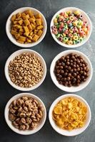 Variety of cold cereals in white bowls photo