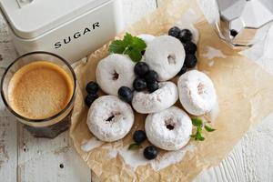 Small donuts in powdered sugar photo