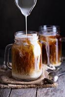 Iced coffee with milk in mason jars