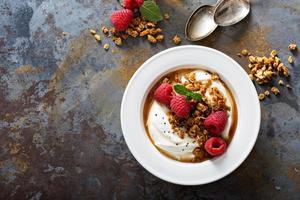 Yogurt bowl with raspberry and maple syrup photo