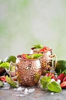 Moscow mule cocktail with lime and strawberry photo