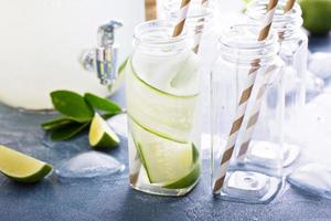 Lime and cucumber lemonade in bottles photo