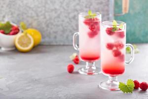 Pink raspberry lemonade in tall glasses photo